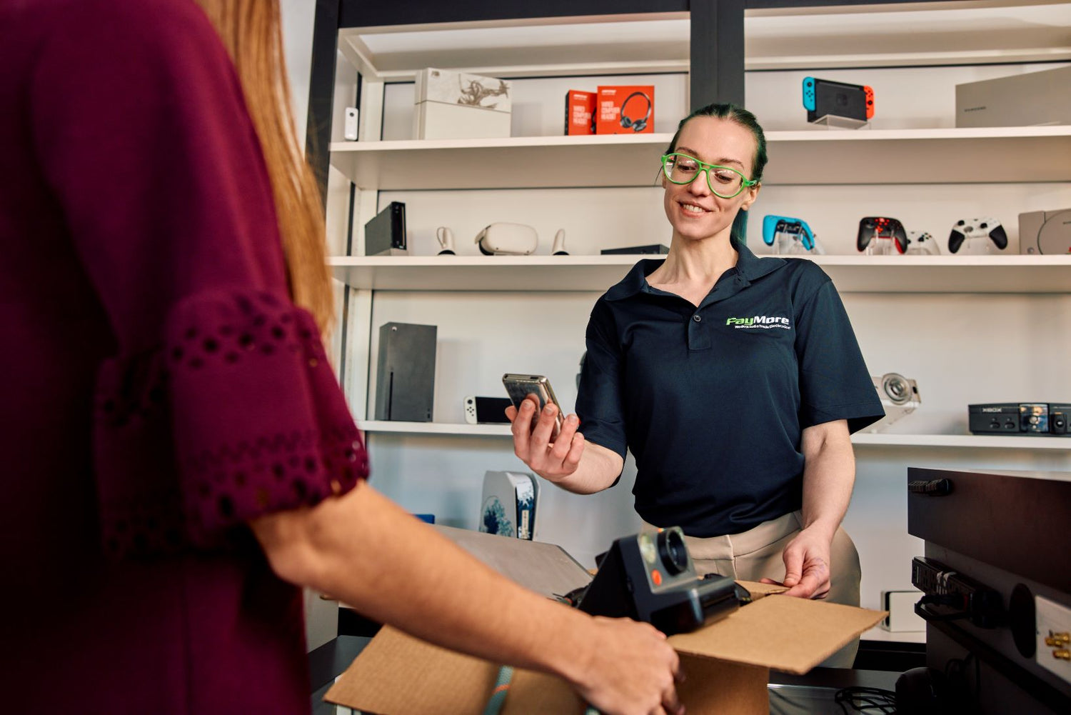 paymore employee inspecting electronics